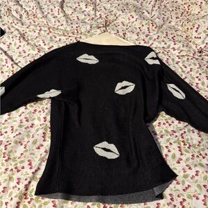 Off-the-Shoulder Black and White Sweater with Lip Print